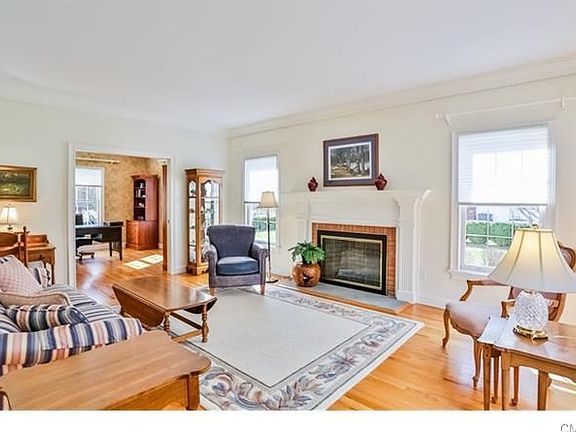 Living Room with wood burning fireplace and elegant crown molding.