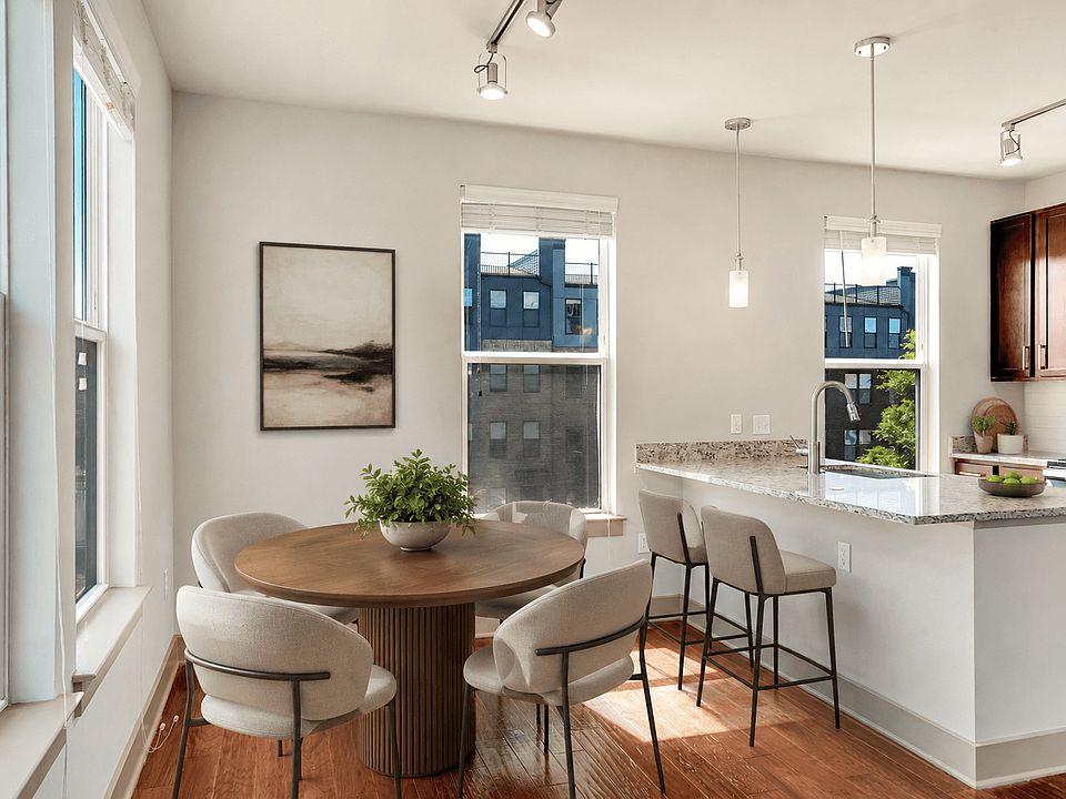 A modern kitchen with a dining table and chairs.