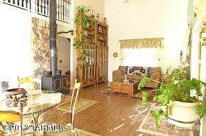 Living room with wood stove & flooring