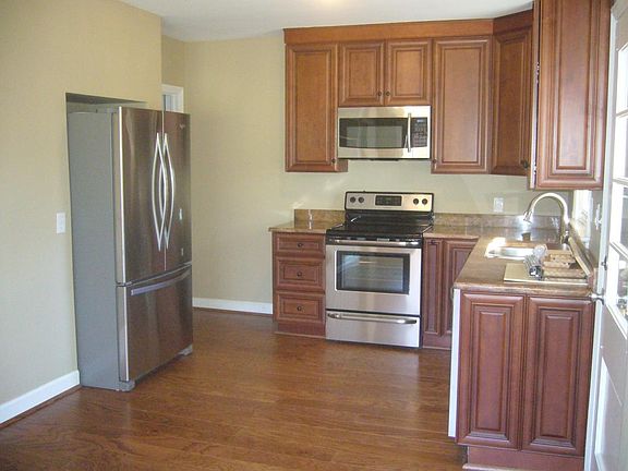 wood laminate flooring in the kitchen and custom cabinetry w