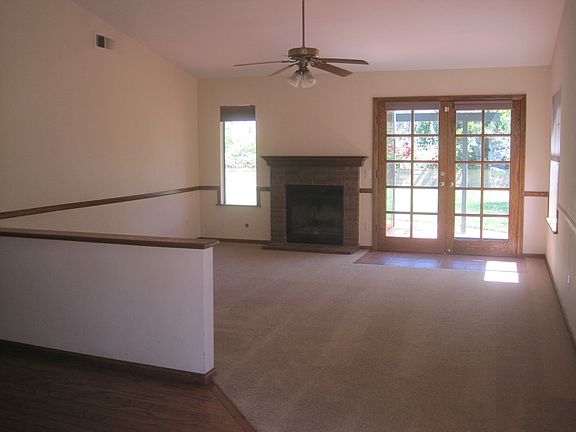 Living room with vaulted ceilings, fireplace and french door