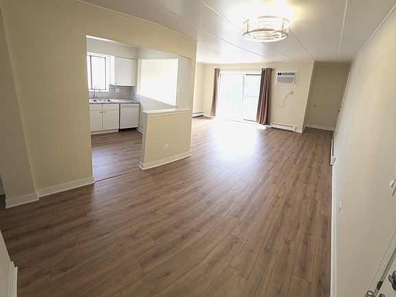 Fully remodeled living room & dining room. New flooring, windows, AC unit, baseboards, blinds, etc.