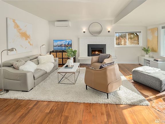 Spacious main floor living room with original Fir wood floors.