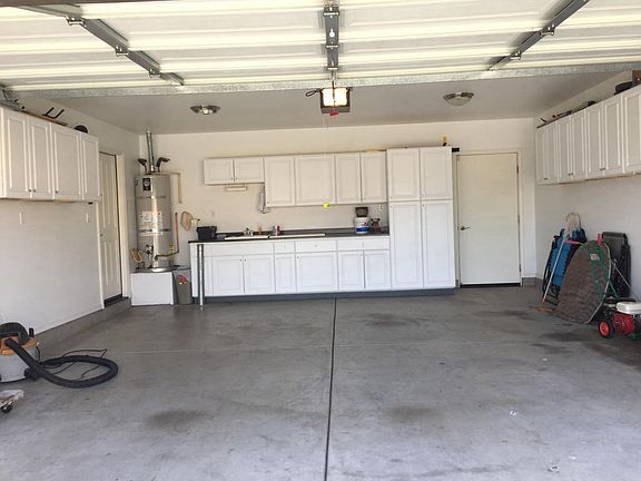 Lots of storage in garage with laundry sink 