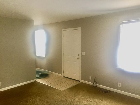 living room with tile entry foyer