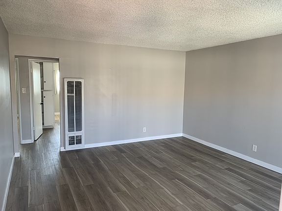 Other view of living room with wall heater
