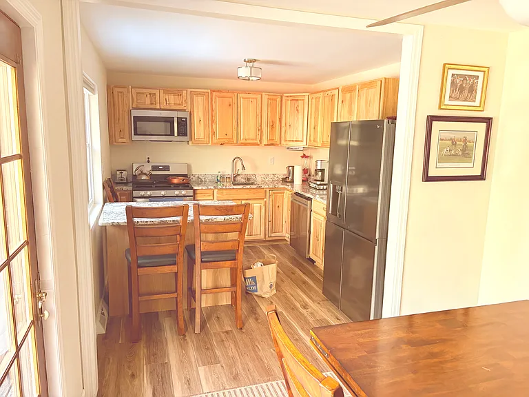 Fully equipped, upscale kitchen with an island/breakfast nook. Features granite countertops, dishwasher, gas stove, Keurig, French press, large refrigerator with ice maker, a full set of utensils, coffee mugs, and a variety of dishware for every occasion.