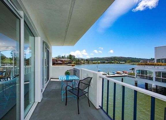 Deck with room for a table, chairs and or a couch to lounge in the sun in the water.