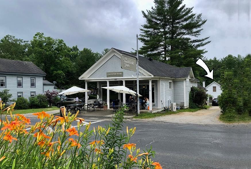 Norfolk Road, center of Southfield Village. Southfield Store and Cafe in foreground. Home visible at the end of the driveway with arrow pointing to it