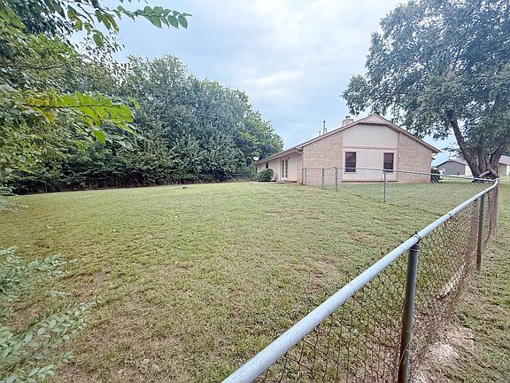 Expansive fenced side yard with privacy and greenbelt views. Great for pets, entertaining, or play space.
