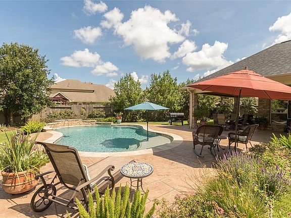 42 Willow Bay Drive. Back yard paradise features lagoon pool with large tanning ledge. There's no place to vacation when it's in your back yard!