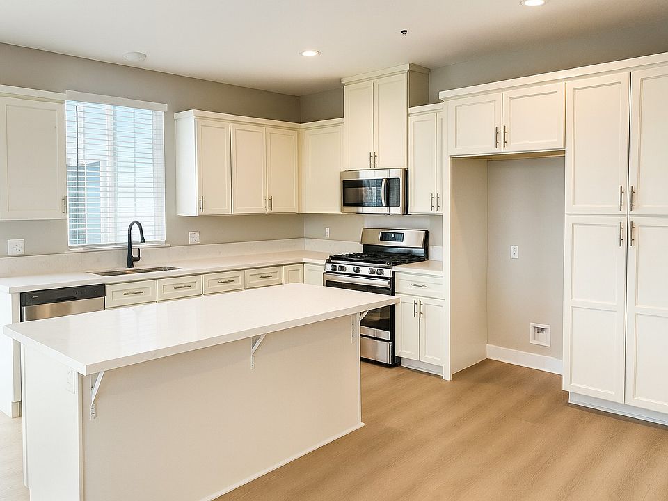 Kitchen with White Shaker Cabinets, Quartz Counter Tops, Large Island and new Appliances.