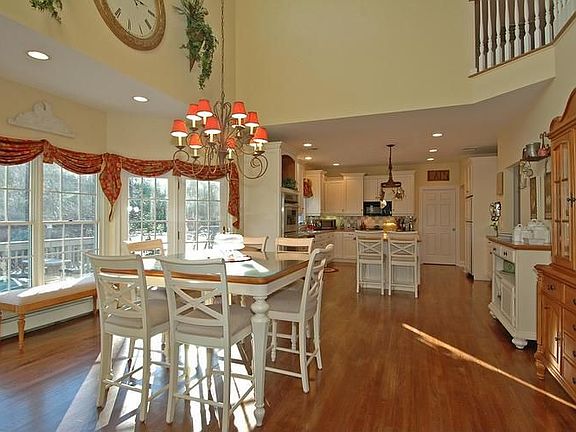 Splendid kitchen offers two-story breakfast room opens to family rm fireplace