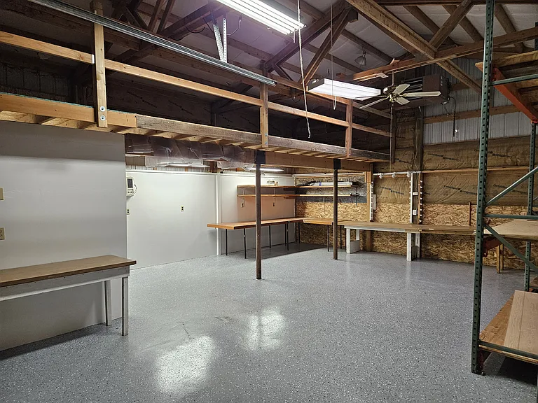 detached garage looking NE showing tables and upper loft with safety railing