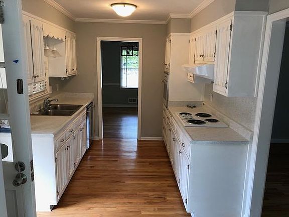Kitchen with doors leading to Sunroom, Family Room and Living/Dining areas