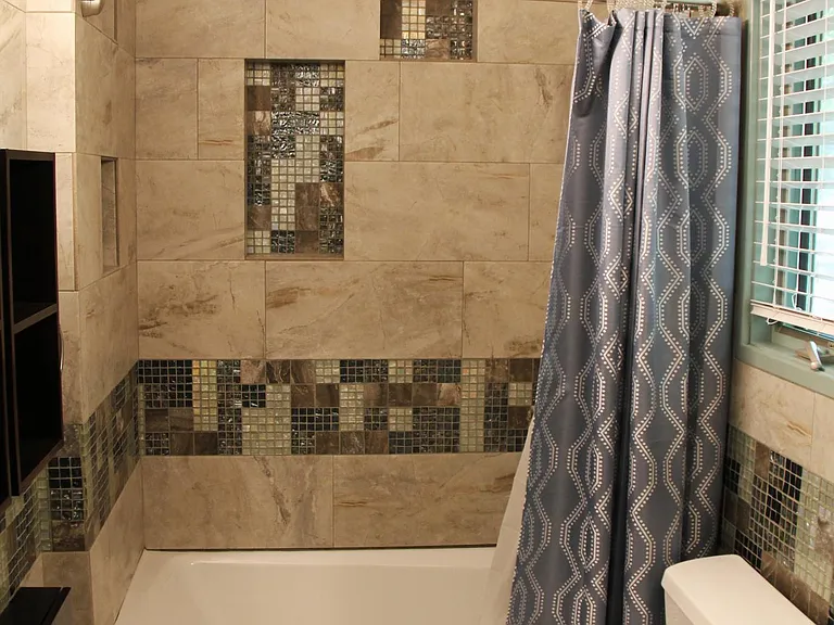Full bathroom with storage space.
