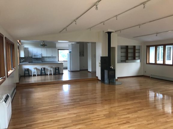 view from living room into kitchen and dining area