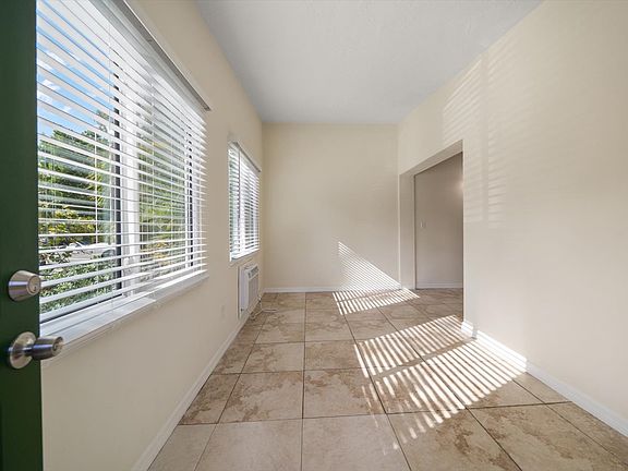 Den with two sliding glass hurricane impact windows