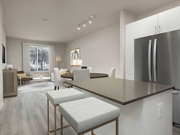 Renovated Package I kitchen with quartz countertops, white cabinetry, stainless steel appliances, hard surface vinyl plank flooring, and tile backsplash