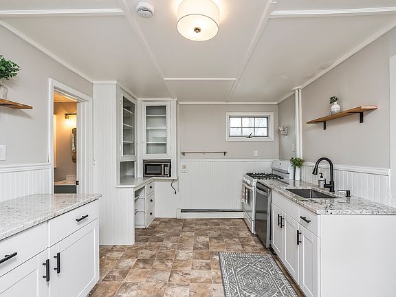 Updated kitchen with brand new granite counter tops, cabinets, and stainless steel dishwasher