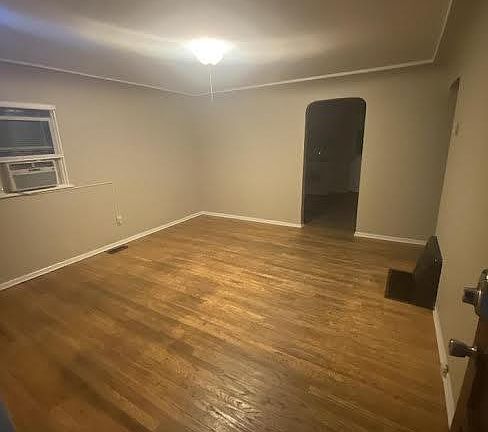 living rooom showing arch door to kitchen and antique plaster work cove ceiling