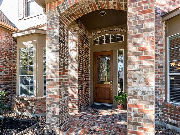 A brick elevation and dormers with tin roofs offers such classic curb appeal! And this arched brick porch houses this charming leaded glass door and welcomes all to enter!