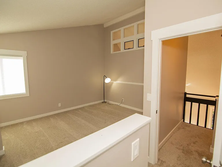Master bedroom at the top of the stairs (vaulted ceiling)