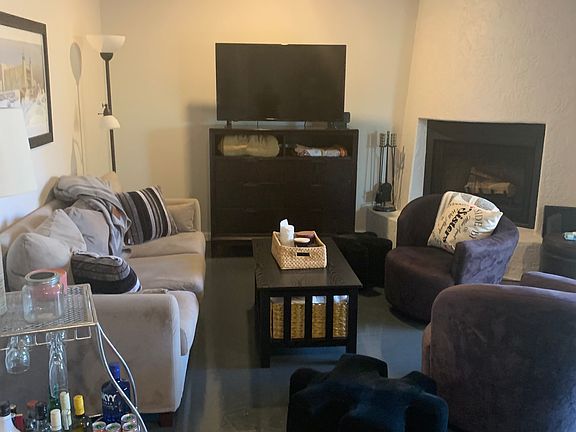 Living room. Sliding door to back patio. Beehive fireplace - best for paper logs or candles.