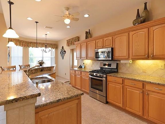 Opposite view of kitchen toward the breakfast/dinette area with under cabinet lighting.