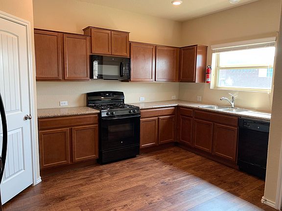 Open kitchen with attached pantry.