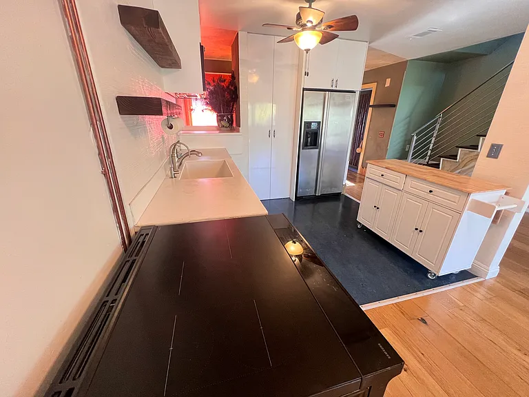Kitchen with stainless steel appliances and glass cooktop