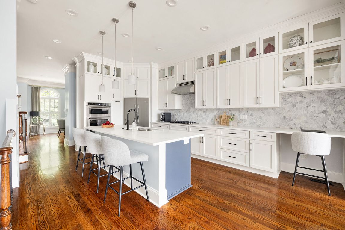 Kitchen - quartz countertops, stainless steel appliances, viking, marble octagonal tile backsplash, hardwood floors, crown molding, ten foot ceilings, custom built-ins, custom moldings, fireplace