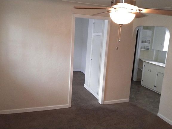 Entry, Living Room with Ceiling Fan, View to Bonus Room (leads to bedroom), and Kitchen beyond