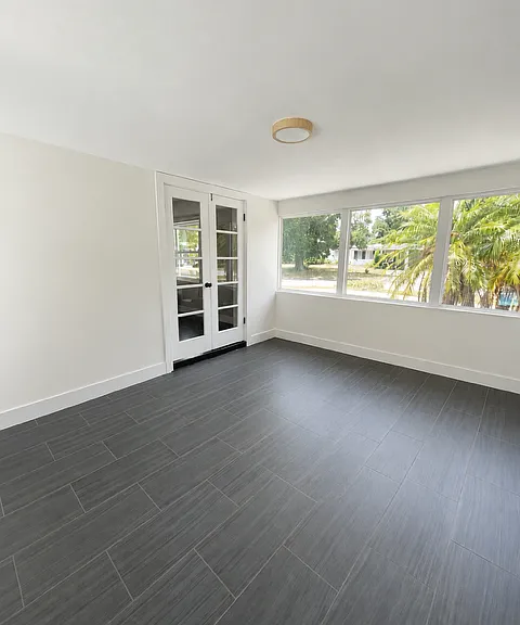 Expansive sunroom that can be used as a home office, media room, or flex space.
