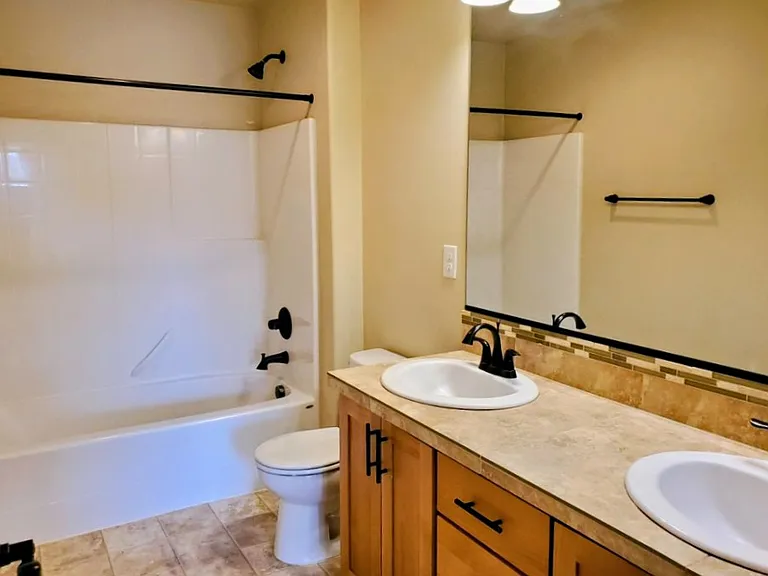 Bathroom 2 with dual sinks and bath tub