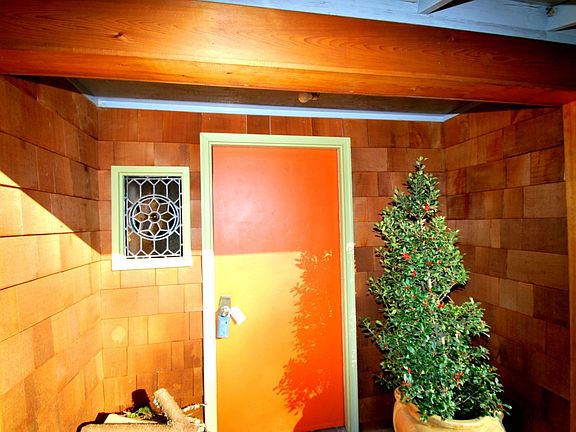 Covered entry with beautiful stained glass window mosaic.