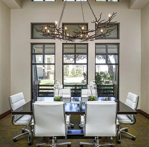 Conference room with large windows and six seated conference table