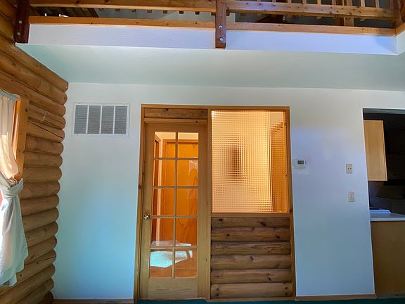 Bathroom door off the living room with loft bedroom above