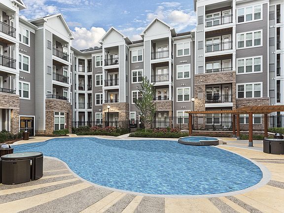 Resort-Style Swimming Pool With Expansive Tanning Areas
