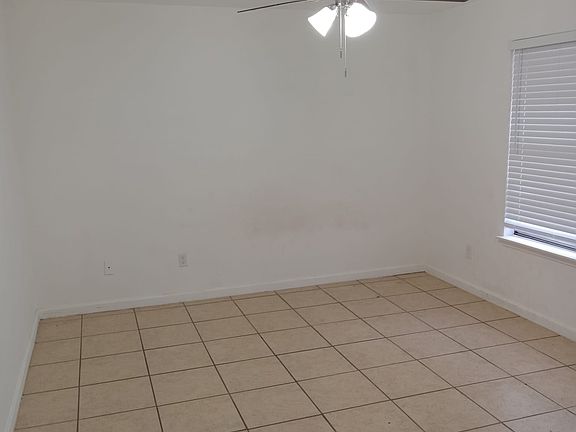 Large master bedroom with 1' wood faux blind, tile, and ensuite restroom