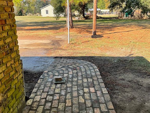 Brick walkway from driveway to back door.