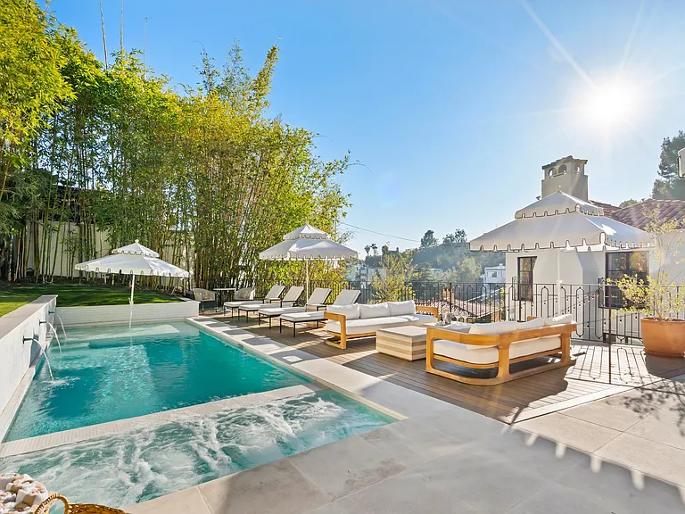 A private oasis with resort-style seating and a sun-drenched pool.