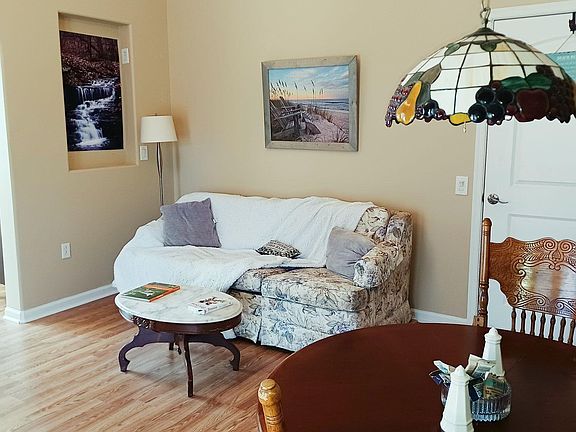 Living area with Sleep Sofa, coffee table, dining room table and chairs