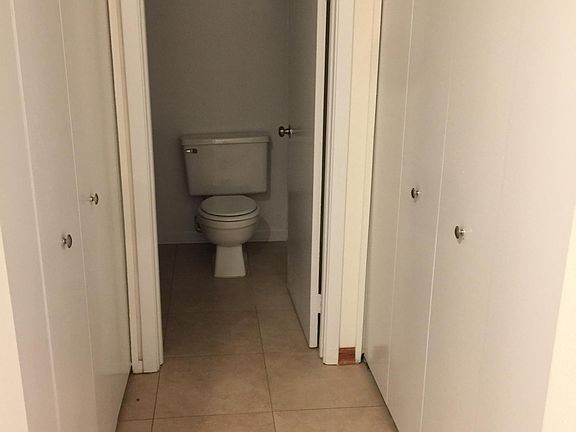 Hallway leading to the bathroom. His and Her closets. 