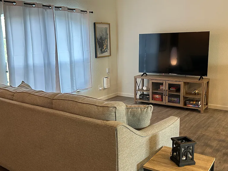 Family room equipped with a smart t v for gaming viewing and scrolling