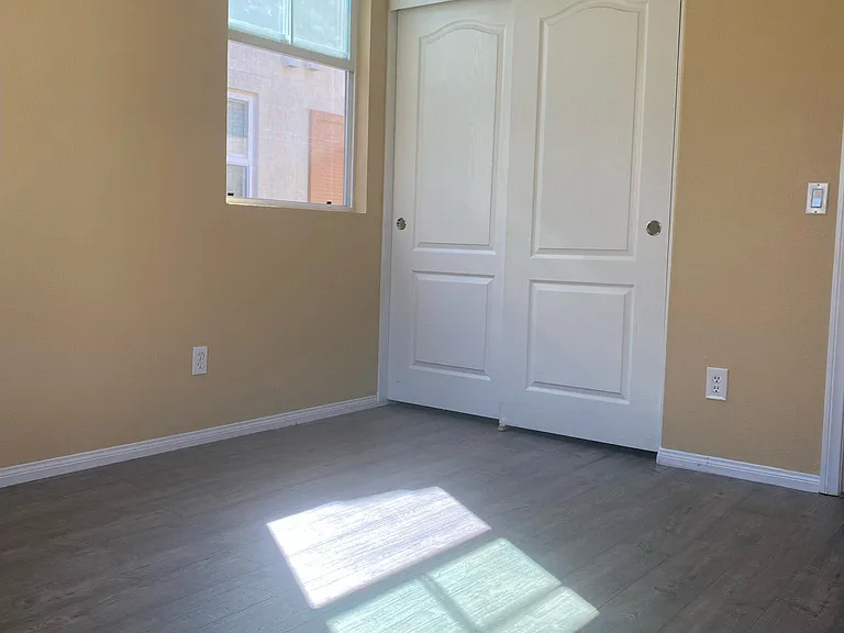 Secondary bedroom with new floors and closet.