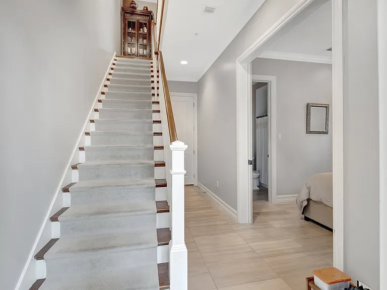 View up 1st floor stairs to kitchen and living room