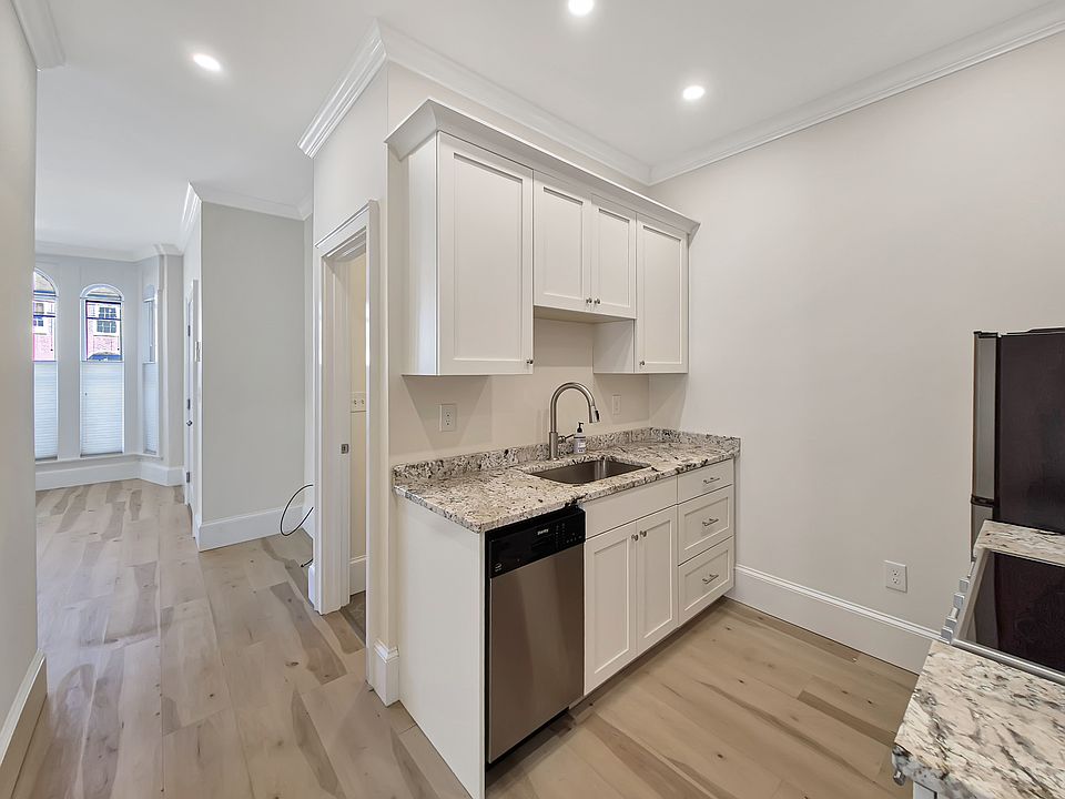 Kitchen leading into the living room with bathroom on the right