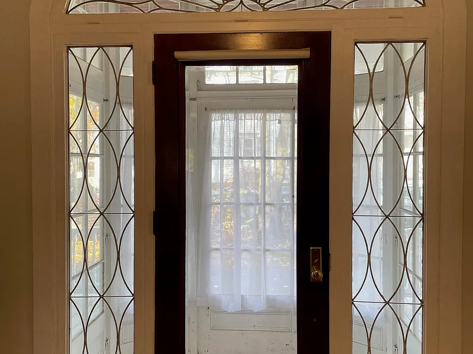 Door to porch with antique leaded glass.
