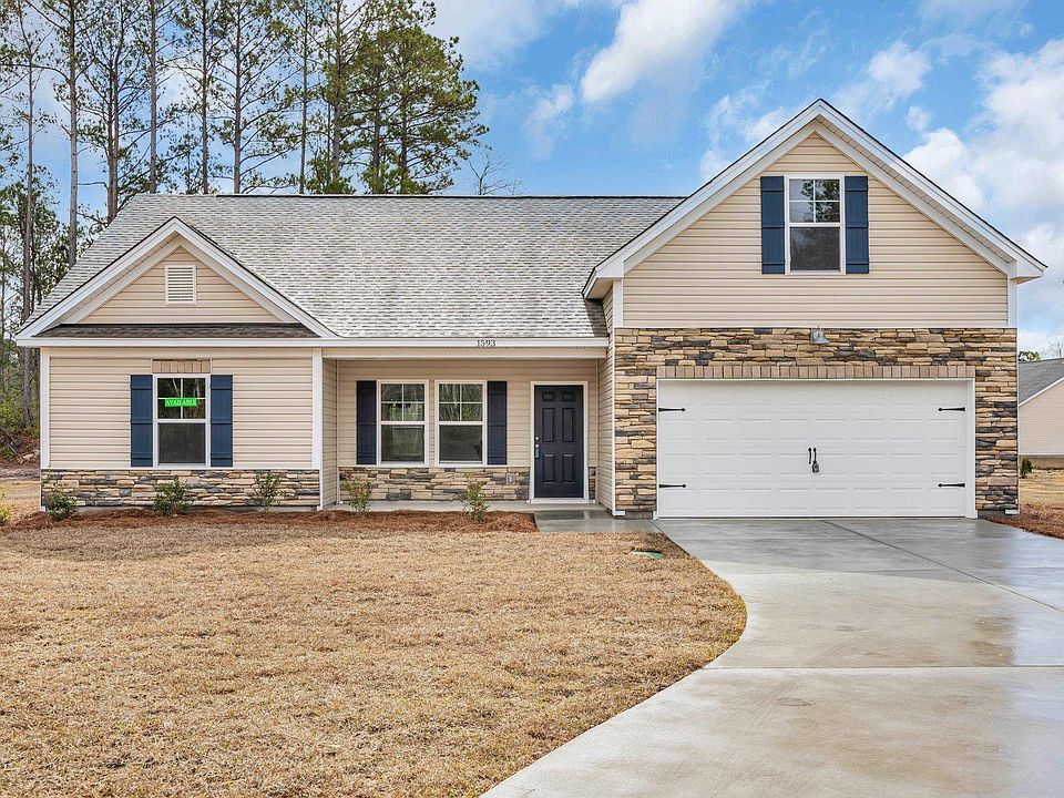 View of front facade featuring a front yard, roof with shingles, an attached garage, concrete drive